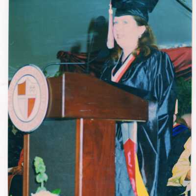 Graduating student, possibly Theresa McGinnis (?), addressing audience during 1999 graduation/commencement.