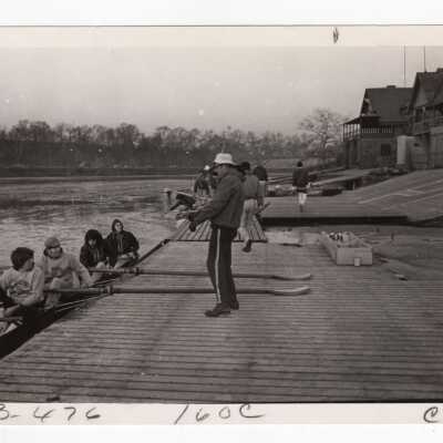 Men's crew/rowing team getting ready to practice in front of Boathouse Row on Schuylkill River.