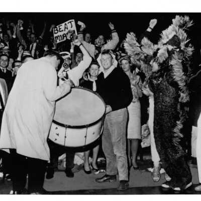 Student booster club and Hawk with drum at pep rally before basketball game, 1964.