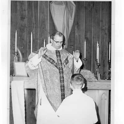 Father Dooley of the Dominican order at mass during Saint Joseph's week, March 1964.