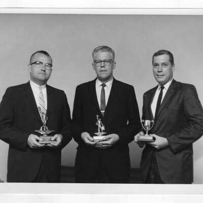 James S. Toothman (Research Director, Food Marketing Program) and two other individuals with awards from essays on "Materials Handling in Marketing," June 1965.