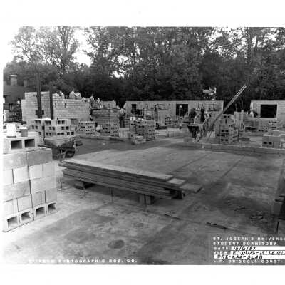 Viewm of early McShain Hall construction with workmen.