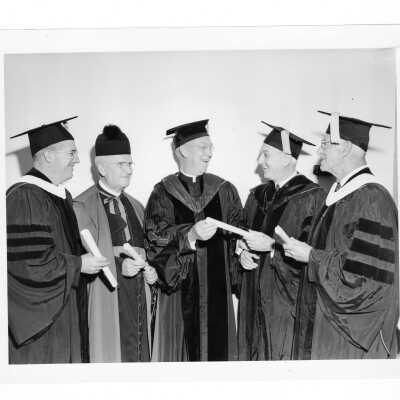 J. Joseph Bluett, S.J., with four honorary degree recipients, Daniel Bernian, F.S.C., Monsignor Leo Fink, S.J., Judge Charles Klein, and Joseph Mattern during October 1961 graduation/commencement.