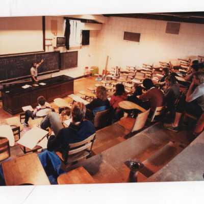 Students attending class in lecture hall with amphitheater style seating in Barbelin Hall.
