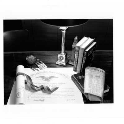 View of desk in Haub Executive Center, McShain Hall with accounting textbooks, diploma, and copy of Wall Street Journal newspaper