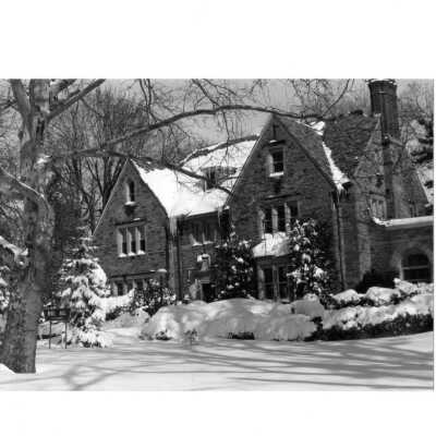 View of front of Regis Hall in snow.