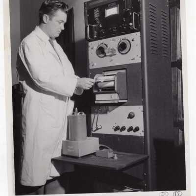 Chemistry professor, Joseph Feighan, reading data from machine in science laboratory, May 1959.