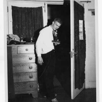 Student from Barry Hall drinking soda in dormitory room.
