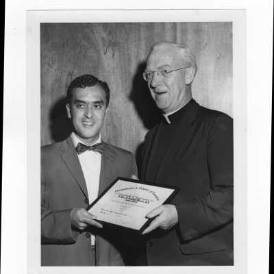 J. Joseph Bluett, S.J., receives certificate of appreciation from Joe Manganero representing Pennsylvania Junior Chamber of Commerce, June 12, 1961.