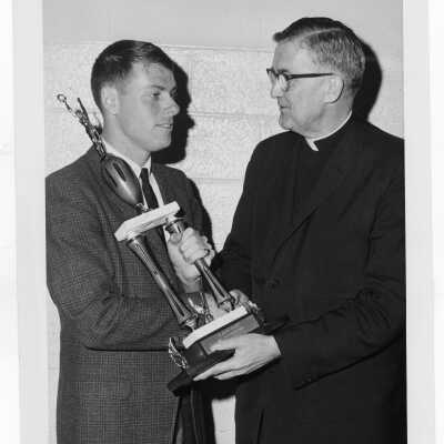 William F. Maloney, S.J. presenting trophy to "outstanding senior" in Villiger Debating Society?
