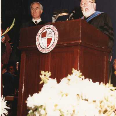 James E. Dougherty reading honorary degree citation to Robert P. Casey, governor of Pennsylvania during 1989 graduation/commencement.