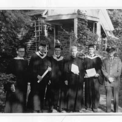 Several graduating students of Quirk Hall with Francis J. Emory, S.J.