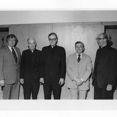 Hogan Alumni Award winner Francis J. Emory, S.J., standing with Donald I. MacLean, S.J., and others, February 23, 1977.