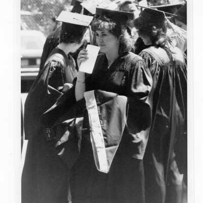 View of graduates assembling for graduation/commencement, c. 1985.