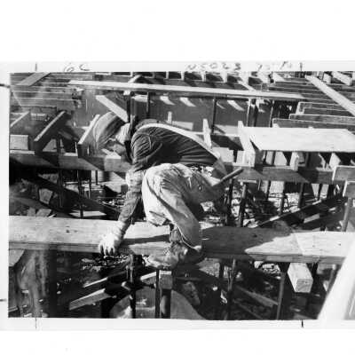 Exterior view of Bellarmine during early construction with workman in foreground.