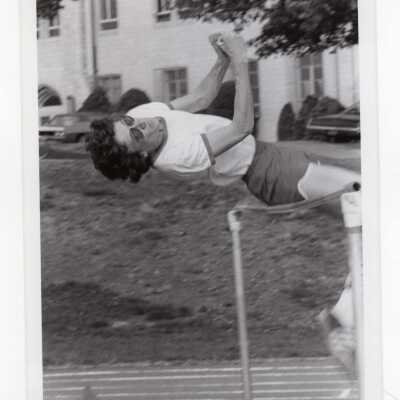 Men's track team member in high jump event.