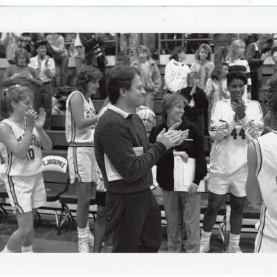 Women's Basketball players at game with Coach