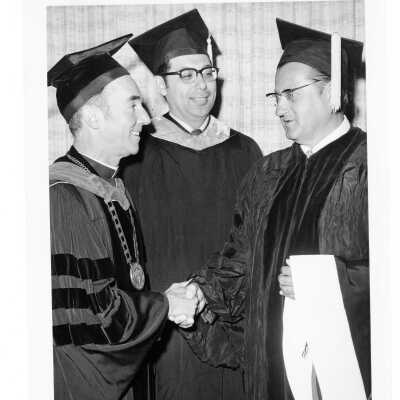 Terrence Toland, S.J., with honorary degree recipients Daniel N. DeLucca (?) and Edward J. Piszek (?) during 1973 graduation/commencement.