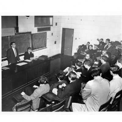 Interior view of lecture hall in Barbelin, possibly physics amphitheater. With students listening to lecture.