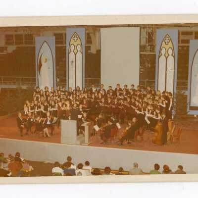 Students in Glee Club and Orchestra performing Christmas concert in Field House.
