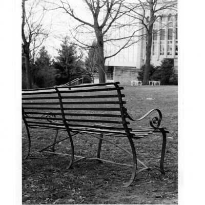 Exterior side view of Drexel Library with park bench in foreground.