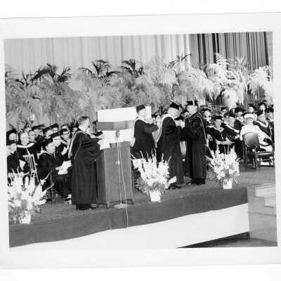 J. Joseph Bluett, S.J. conferring to James A. Donnellon, O.S.A. (?) President of Villanova University during 1959 graduation/commencement.