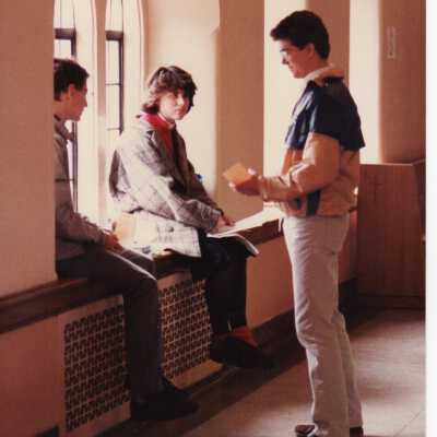 Interior view of students sitting in window alcove in hallway in Barbelin building.