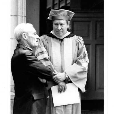 Faculty, Michael J. Smith, S.J., and honorary degree recipient during graduation/commencement, c. 1984.