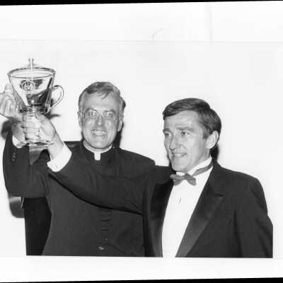 Donald I. MacLean, S.J., with John F. Lehman, Jr., recipient of 1985 Shield of Loyola Award, holding award cup, September 20, 1985.