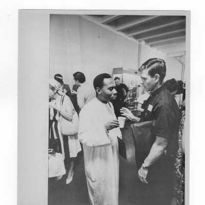 Pax Romana's 20th World Plenary Assembly meets at Saint Joseph's College, August 1968. View of attendees taking a break in the Field House lobby.