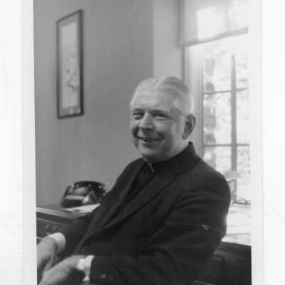 Lawrence R. McHugh, S.J., sitting in his office.