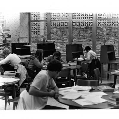 Interior view of reading room in Drexel Library with students studying at desks.