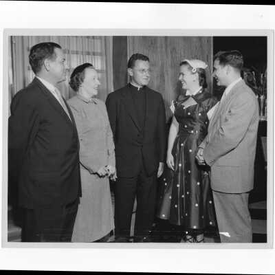 Edward G. Jacklin, S.J., with alumni officers and their wives, Mr. and Mrs. Francis Lammer, and Mr. and Mrs. William Ariano, at a reception, September 11, 1955.