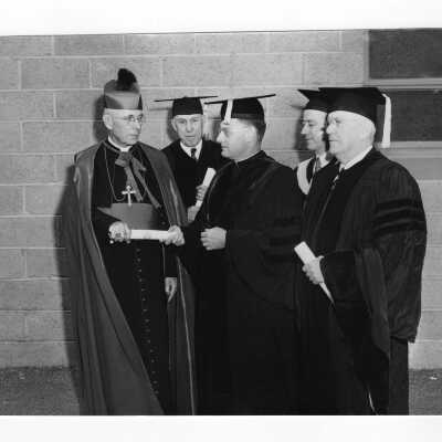 Edward G. Jacklin, S.J. with honorary degree recipients, Bishop John F. O'Hara, Francis J. Hardart, and Joseph Breen, and Bartholomew A. Sheehan, speaker, at 1954 graduation/commencement ceremony.