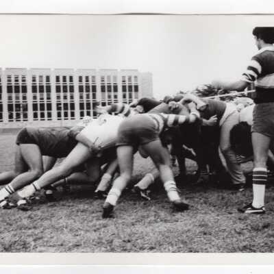 Men's rugby players huddling during match.