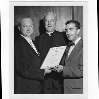 Air Force captain, Joseph Manganero, receiving alumni association Charter award from J. Joseph Bluett, S.J., and Frank X. Duff, June 1, 1961.