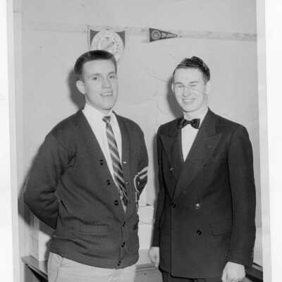Two students of Barry Hall, one wearing letter sweater and the other a tuxedo.
