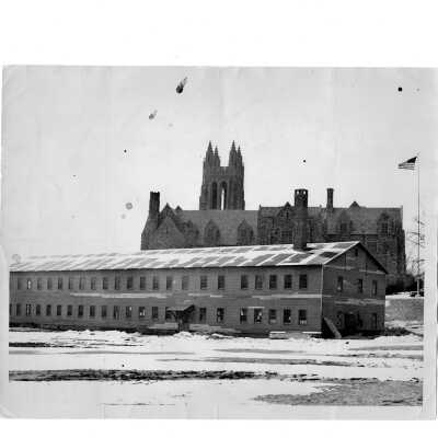 Exterior view of Cardboard College (also known as Barbelin Annex) with snow on ground and Barbelin building in background.