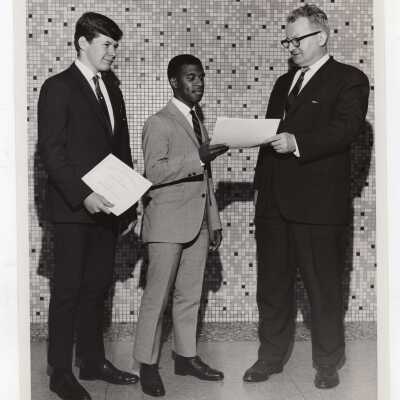 George Beichl awarding certificates of merit to two high school students for participating in Chemistry Department's Science Motivation Program, spring 1968.