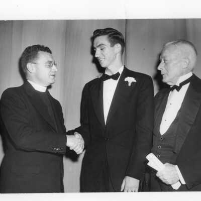 Edward G. Jacklin, S.J., Daniel L. Shields (class of 1951), and John J. Sullivan (class of 1896) at banquet held in Field House as part of centennial anniversary celebration.