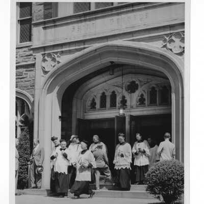 Jesuit faculty leaving Saint Barbara's Church after Baccalaureate service as part of 1947 graduation/commencement service.