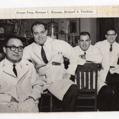 Graduate chemistry students--including George Fong, Herman C. Hamann, Richard A. Torykian, and another individual--sitting in science laboratory, c. 1965.