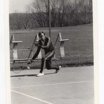 Men's tennis team player practicing.