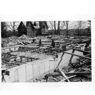 View of Campion under construction with workmen and Siimpson Hall in background.