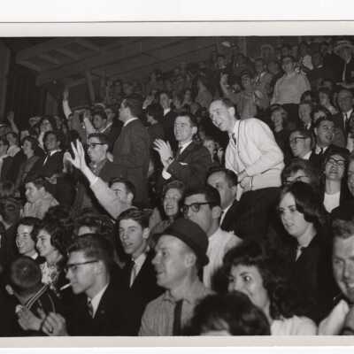 Men's Basketball, student crowd watching game.