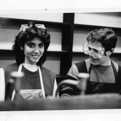 Two students working on experiment in science laboratory.