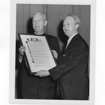 Frank X. Duff, president of alumni association, presenting award to J. Joseph Bluett, S.J., honoring him and faculty members, May 3, 1962.