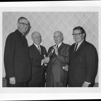 Charles A. Waters holding Law Alumni Award with William F. Maloney, S.J., and others, November 28, 1967.
