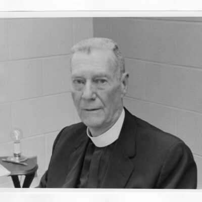 John S. O'Conor, S.J. (Physics), one photo in office and the second with students in laboratory.