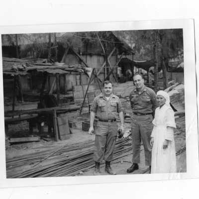 Two U.S. soldiers with Vietnamese nun, Vietnam Orphanage project.